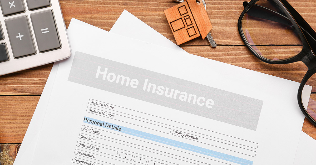 Homeowners insurance application with house keys and calculator, illustrating the challenges of selling a house without insurance in Massachusetts.