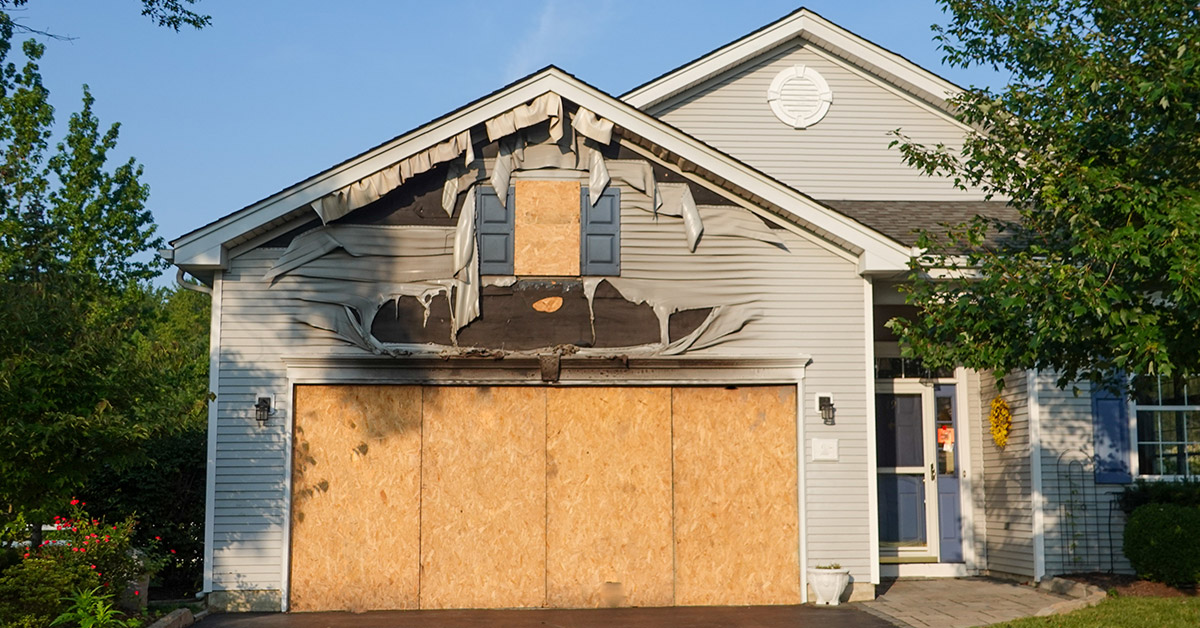 Collapsing garage in Massachusetts with a damaged roof and structural deterioration